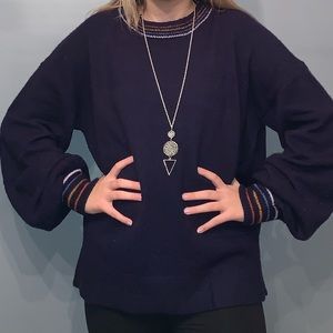 Navy blue sweater with balloon sleeves.